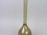 a glass vase that is sitting on a white surface