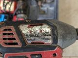 a drill that is sitting on a table next to other tools