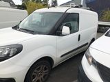 a white van parked in a parking lot next to other cars