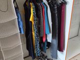 a closet with a rack of clothes on it