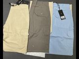 three pairs of men ' s cargo shorts with tags on them