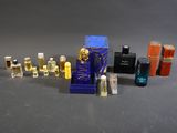 a lot of perfume bottles and a bottle of perfume on a table