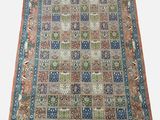 an antique persian rug with a multicolored design