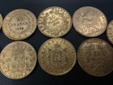six different types of coins are shown on a black surface