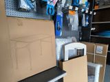 a cardboard box sitting on top of a shelf next to a chair