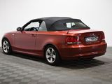 an image of a red convertible car parked on a checkered floor