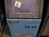 une petite machine bleue surmontée d'un chapeau blanc