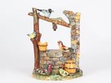 a figurine of a well with birds on it