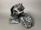 a statue of a dog that is sitting on the ground