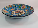 a blue bowl with a floral design on it