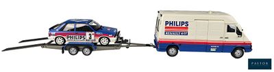 a toy truck pulling a toy car on a trailer