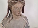 a statue of a woman with a hat on top of her head