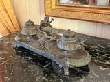 a marble counter top with a clock on it and a mirror in the background