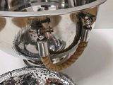 a silver bowl with a rope around it and a silver bowl with a rope around it