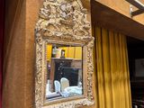 a mirror hanging on the wall next to a table