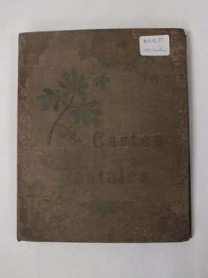 un vieux livre posé sur une table blanche à côté d'un mur blanc