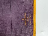 the purple and yellow tie is on the white table