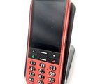 a red cell phone sitting on top of a cell phone stand