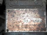 a rusted metal plate on the side of a vehicle