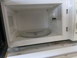 a white microwave with a glass plate inside of it