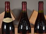 three bottles of wine that are sitting on a table