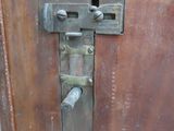 a close up of a metal latch on a wooden door
