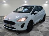 the white ford fiesta is parked in a room with a checkered floor