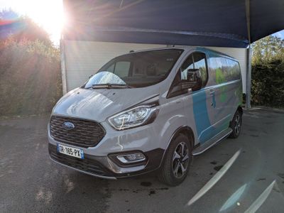 a white van with a blue stripe parked in front of a building
