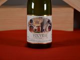 a bottle of wine sitting on a red table cloth
