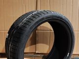 tire on the floor next to a cardboard box with a cardboard box in the background