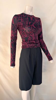 an image of a mannequin wearing a red and black top and black shorts