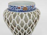 a white vase with a blue and white design on it