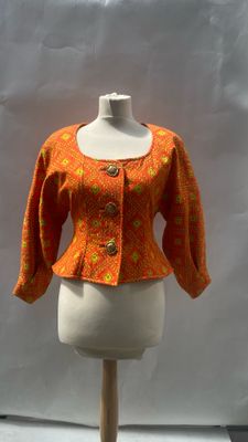an orange jacket on a mannequin with a white background
