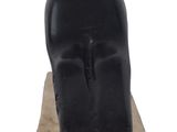 statue of a black cat sitting on a block on a white background
