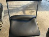 a black chair that is sitting in a garage