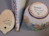 two vases and a spoon sitting on a table