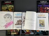 several books are lined up on a table with drawings on them