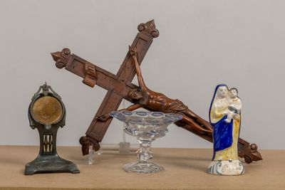 une statue de Jésus sur la croix et d'autres objets religieux posés sur une table