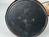 a black pan with a lid sitting on a white surface