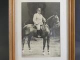 an old photo of a man riding a horse in a wooden frame