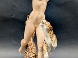 figurine of a nude woman with a leopard on her shoulder