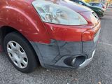 an image of a car with a denting front bumper