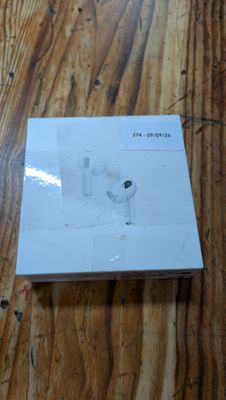 an apple airpods are sitting on top of a box on a wooden table