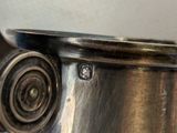a close up of a silver coffee pot on a table