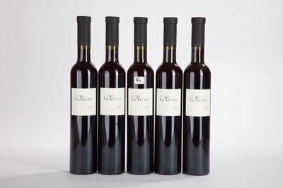 three bottles of wine are lined up against a white background