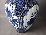 a blue and white vase sitting on a table
