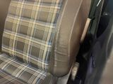 a close up of a car seat with a checkered seat cover