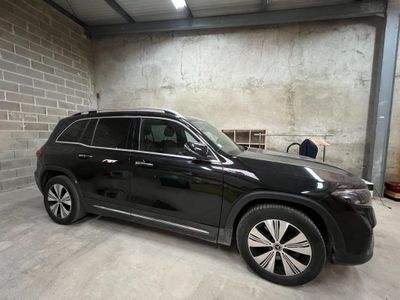 the black suv is parked in the garage of a building