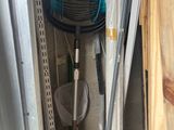 an image of a room that has a fan and pipes in it