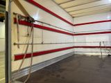 a garage with a red and white stripe painted on the wall